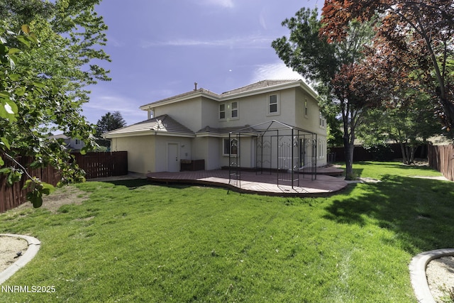 3323 Deer Ridge Ct, Reno, NV 89509 - back of house featuring stucco siding, a fenced backyard, and a deck