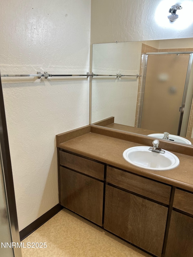 1000 Beck St Unit 361, Reno, NV 89509 - bathroom with vanity, a textured wall, and an enclosed shower