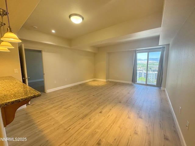 200 W 2nd St Unit 1107, Reno, NV 89501 - unfurnished living room with light wood-type flooring, a raised ceiling, and recessed lighting