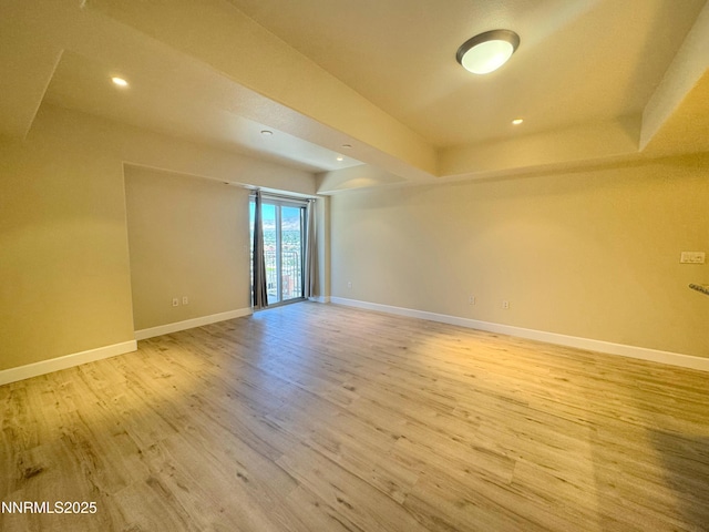 200 W 2nd St Unit 1107, Reno, NV 89501 - unfurnished room with light wood finished floors, recessed lighting, and a tray ceiling