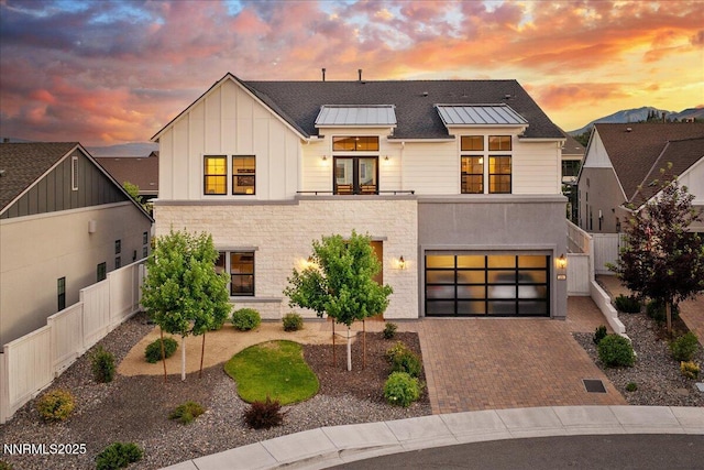 206 Criollo Ct, Reno, NV 89511 - modern farmhouse featuring decorative driveway, a garage, board and batten siding, stone siding, and a standing seam roof