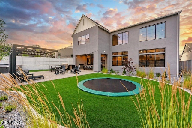 206 Criollo Ct, Reno, NV 89511 - rear view of house with a trampoline, a patio, stucco siding, and a pergola
