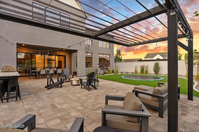 206 Criollo Ct, Reno, NV 89511 - patio terrace at dusk featuring an outdoor living space with a fire pit, a patio area, a pergola, and outdoor dining area