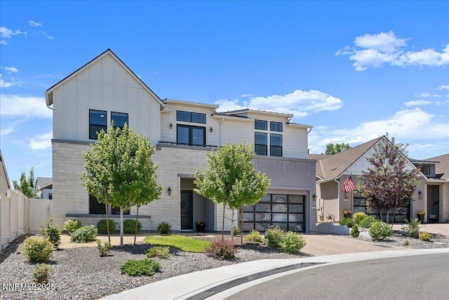 206 Criollo Ct, Reno, NV 89511 - modern home featuring driveway, a garage, stone siding, and board and batten siding
