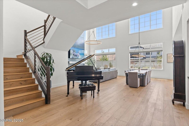 206 Criollo Ct, Reno, NV 89511 - living area with light wood-style flooring, stairs, a towering ceiling, and recessed lighting