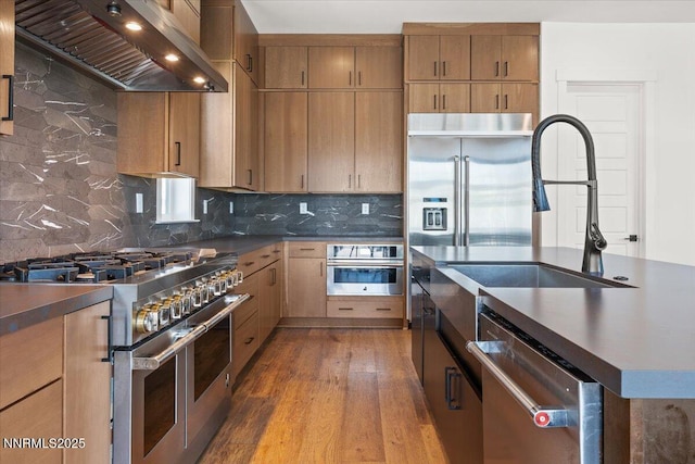 206 Criollo Ct, Reno, NV 89511 - kitchen featuring stainless steel appliances, wall chimney exhaust hood, dark countertops, and backsplash