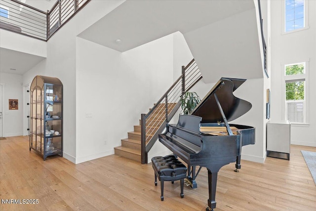 206 Criollo Ct, Reno, NV 89511 - entryway featuring a towering ceiling, wood finished floors, stairs, and arched walkways