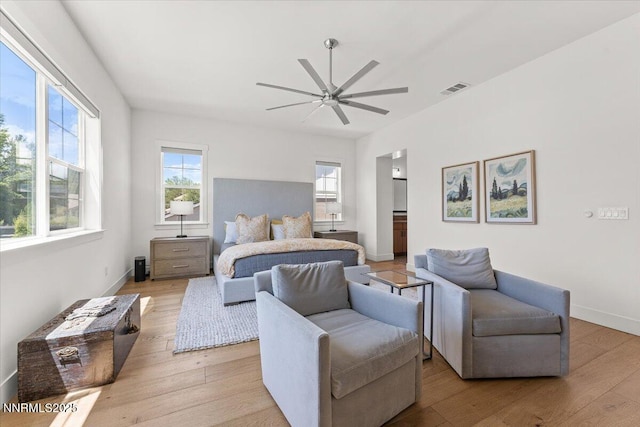 206 Criollo Ct, Reno, NV 89511 - bedroom with multiple windows, light wood-style flooring, ensuite bath, and a ceiling fan