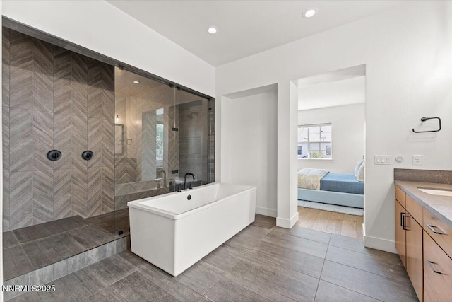 206 Criollo Ct, Reno, NV 89511 - ensuite bathroom with a freestanding tub, vanity, tiled shower, recessed lighting, and tile patterned floors