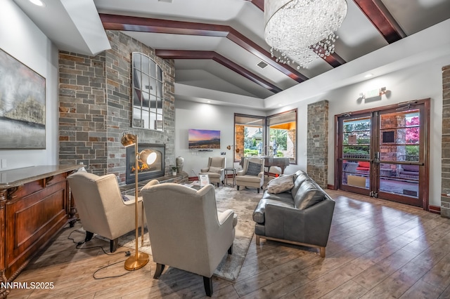 900 S Meadows Pkwy Apt 322, Reno, NV 89521 - living room featuring a large fireplace, hardwood / wood-style flooring, and a chandelier