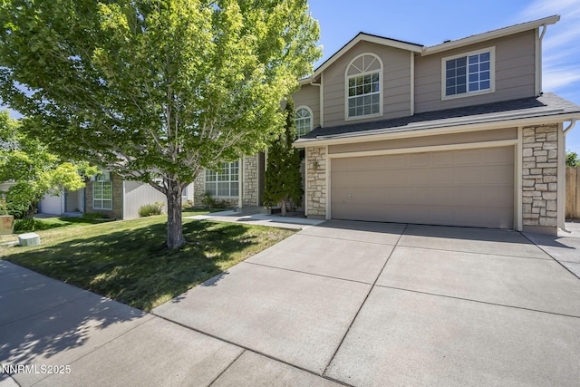 940 Skyway Dr, Reno, NV 89523 - view of front facade featuring stone siding, concrete driveway, a garage, and a front yard