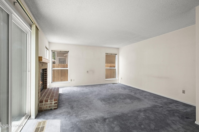 940 Skyway Dr, Reno, NV 89523 - unfurnished living room featuring a textured ceiling, a fireplace, and carpet flooring