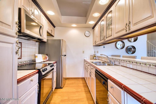 128 Holly Ln Unit B, Stateline, NV 89449 - kitchen featuring stainless steel microwave, dishwasher, electric stove, tile countertops, and light wood finished floors