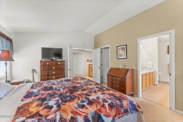 976 Leah Cir, Reno, NV 89511 - bedroom with vaulted ceiling, light colored carpet, ensuite bathroom, and a textured ceiling