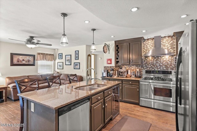 976 Leah Cir, Reno, NV 89511 - kitchen with wall chimney exhaust hood, stainless steel appliances, beverage cooler, open floor plan, and recessed lighting