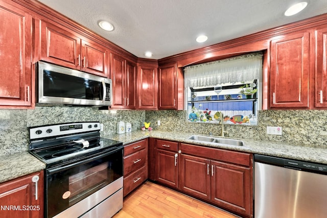 3510 Rancho Cir S, Lake Tahoe, CA 96150 - kitchen featuring stainless steel appliances, light wood-style flooring, backsplash, dark brown cabinets, and recessed lighting