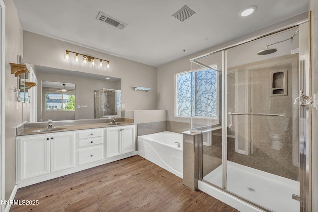 2182 Talladega Ct, Sparks, NV 89436 - full bath with a stall shower, a bath, double vanity, a ceiling fan, and wood finished floors