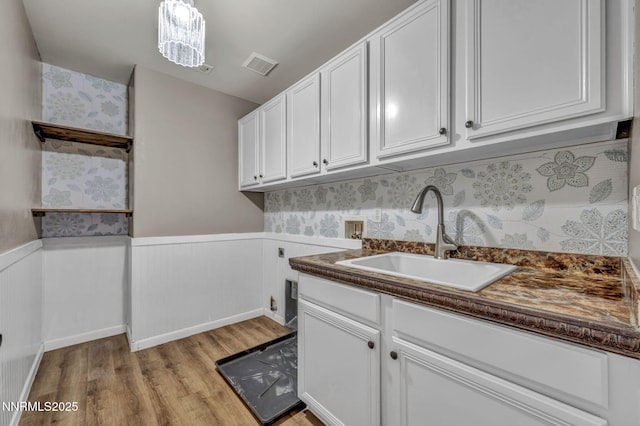 2182 Talladega Ct, Sparks, NV 89436 - washroom with washer hookup, light wood-style floors, cabinet space, wainscoting, and electric dryer hookup