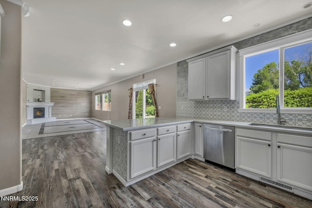 2182 Talladega Ct, Sparks, NV 89436 - kitchen with stainless steel dishwasher, a peninsula, dark wood finished floors, open floor plan, and light countertops