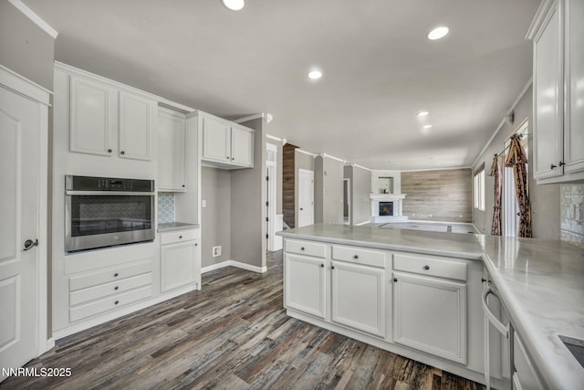 2182 Talladega Ct, Sparks, NV 89436 - kitchen with stainless steel oven, white cabinets, open floor plan, and recessed lighting
