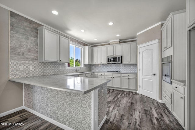 2182 Talladega Ct, Sparks, NV 89436 - kitchen with appliances with stainless steel finishes, a peninsula, dark wood-style floors, decorative backsplash, and light countertops