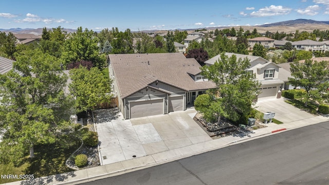 2182 Talladega Ct, Sparks, NV 89436 - view of front of home featuring driveway, a mountain view, a residential view, and a garage