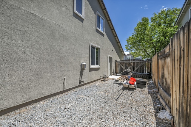 2182 Talladega Ct, Sparks, NV 89436 - view of side of home featuring a fenced backyard, stucco siding, and a patio area