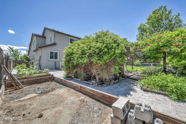 2182 Talladega Ct, Sparks, NV 89436 - back of house featuring a garden, stucco siding, and a patio