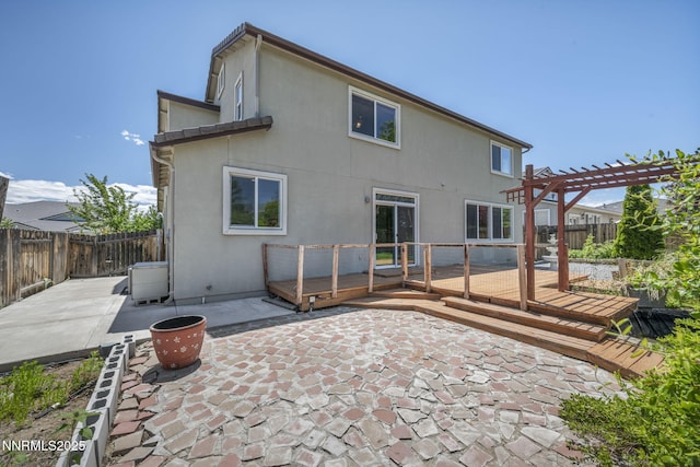 2182 Talladega Ct, Sparks, NV 89436 - rear view of property featuring a pergola, a deck, stucco siding, and a fenced backyard