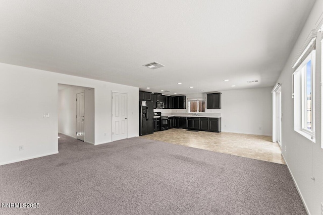 10965 Bloomsburg Dr, Reno, NV 89506 - unfurnished living room featuring light carpet and recessed lighting