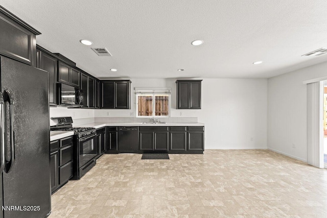 10965 Bloomsburg Dr, Reno, NV 89506 - kitchen featuring black appliances, dark cabinetry, light countertops, and recessed lighting