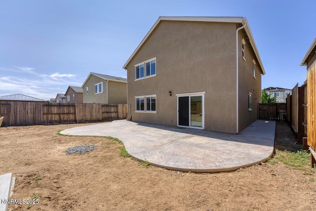 10965 Bloomsburg Dr, Reno, NV 89506 - rear view of property featuring a patio area, stucco siding, and a fenced backyard