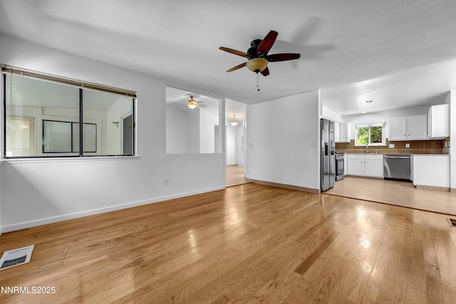 185 Marmot Dr, Reno, NV 89523 - unfurnished living room with a ceiling fan and light wood-type flooring