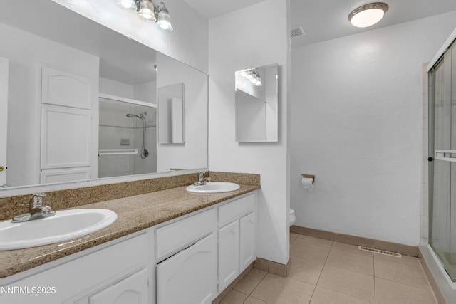 185 Marmot Dr, Reno, NV 89523 - full bathroom featuring a stall shower, double vanity, and tile patterned flooring