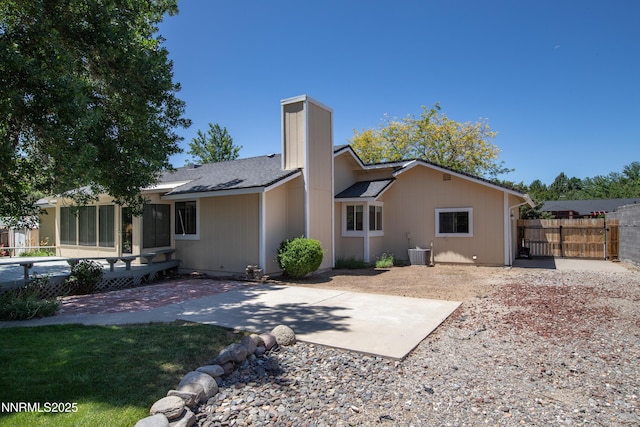 185 Marmot Dr, Reno, NV 89523 - back of house with a patio area, a chimney, and a sunroom