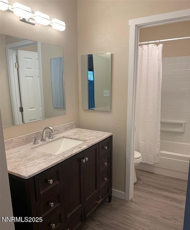 2450 Lymbery St Apt 107, Reno, NV 89509 - full bathroom featuring wood finished floors, vanity, shower / bath combination with curtain, and a textured wall