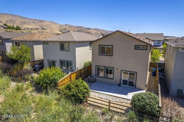 1825 Star Bright Way, Reno, NV 89523 - back of house featuring a fenced backyard, a patio area, stucco siding, and a mountain view