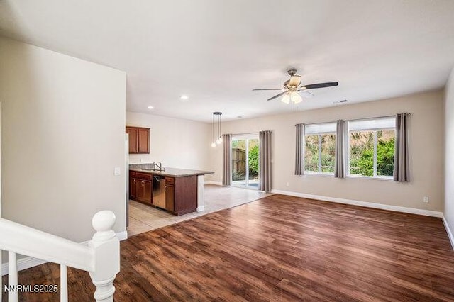 1825 Star Bright Way, Reno, NV 89523 - kitchen featuring light wood finished floors, a ceiling fan, open floor plan, pendant lighting, and stainless steel dishwasher