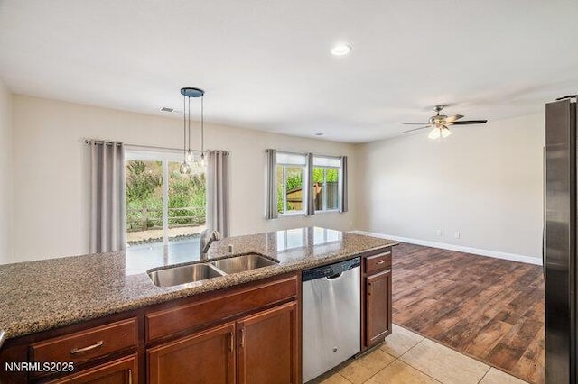 1825 Star Bright Way, Reno, NV 89523 - kitchen featuring stainless steel appliances, a ceiling fan, dark stone countertops, hanging light fixtures, and recessed lighting