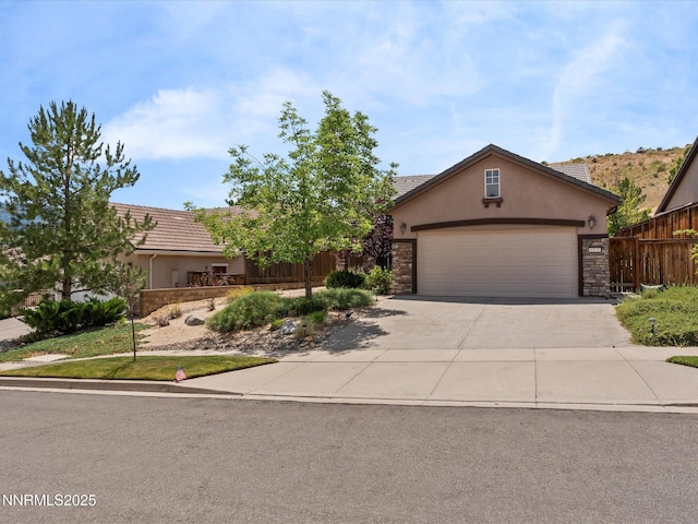 1835 Trail Creek Way, Reno, NV 89523 - view of front of house featuring stucco siding, driveway, stone siding, and an attached garage