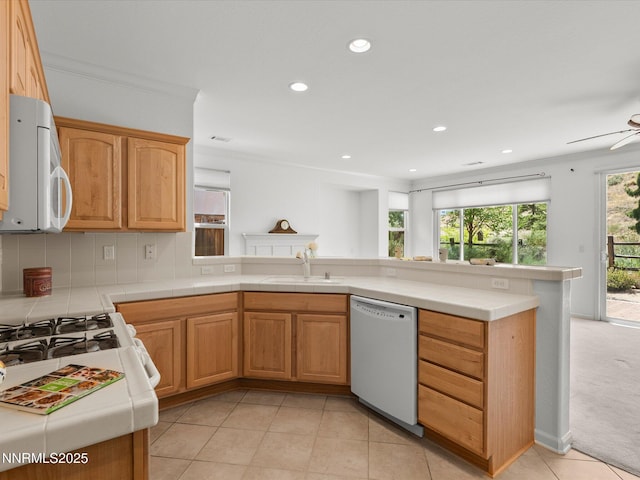 1835 Trail Creek Way, Reno, NV 89523 - kitchen featuring white appliances, tile counters, a peninsula, light tile patterned flooring, and a ceiling fan