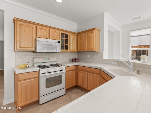 1835 Trail Creek Way, Reno, NV 89523 - kitchen with white appliances, tile counters, ornamental molding, tasteful backsplash, and light tile patterned flooring