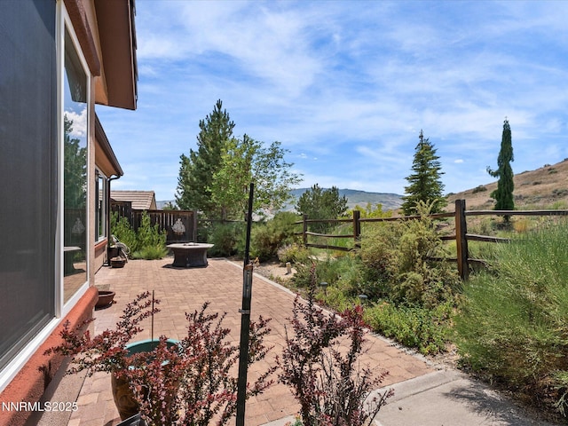 1835 Trail Creek Way, Reno, NV 89523 - fenced backyard with a patio, a fire pit, and a mountain view