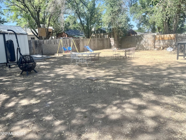 109 M St, Sparks, NV 89431 - view of yard featuring a playground, a shed, and an outdoor fire pit