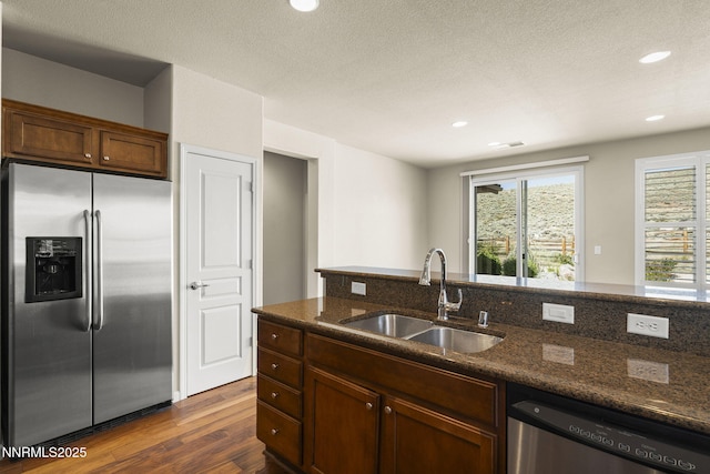 1245 W Del Webb Pkwy, Reno, NV 89523 - kitchen with stainless steel appliances, dark wood finished floors, dark stone countertops, and recessed lighting