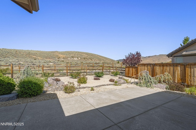 1245 W Del Webb Pkwy, Reno, NV 89523 - fenced backyard featuring a mountain view and a patio area