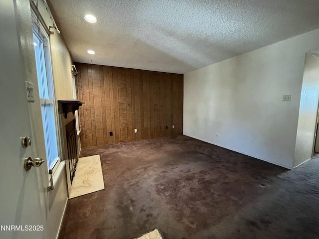 972 Flatcar Ln, Sparks, NV 89431 - spare room featuring carpet flooring, wood walls, a textured ceiling, and recessed lighting