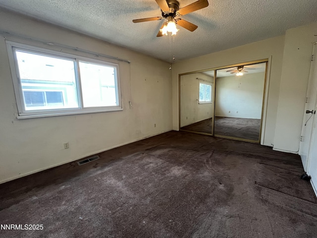 972 Flatcar Ln, Sparks, NV 89431 - unfurnished bedroom with a textured ceiling, a closet, carpet, and ceiling fan