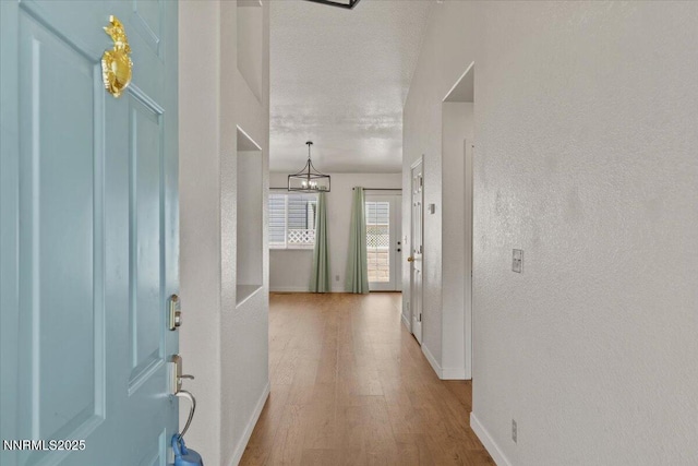 7560 Lighthouse Ln, Reno, NV 89511 - foyer with wood finished floors, a chandelier, and a textured wall