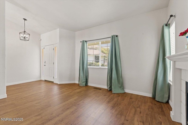 7560 Lighthouse Ln, Reno, NV 89511 - unfurnished room featuring wood finished floors and a chandelier